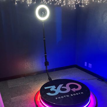 360 photo booth with ring light and colorful LED base.