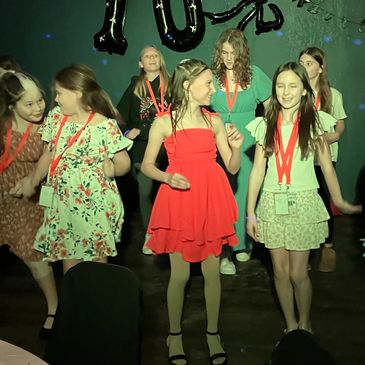 Group of girls dancing at an event.
