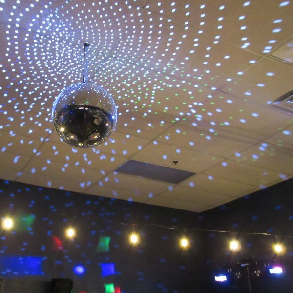 The dance floor at Chelsea Party Loft in Chelsea, Michigan, is disco lighting and mirror ball.