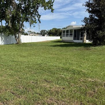 Newly maintained lawn and landscaping surrounding a residential property.