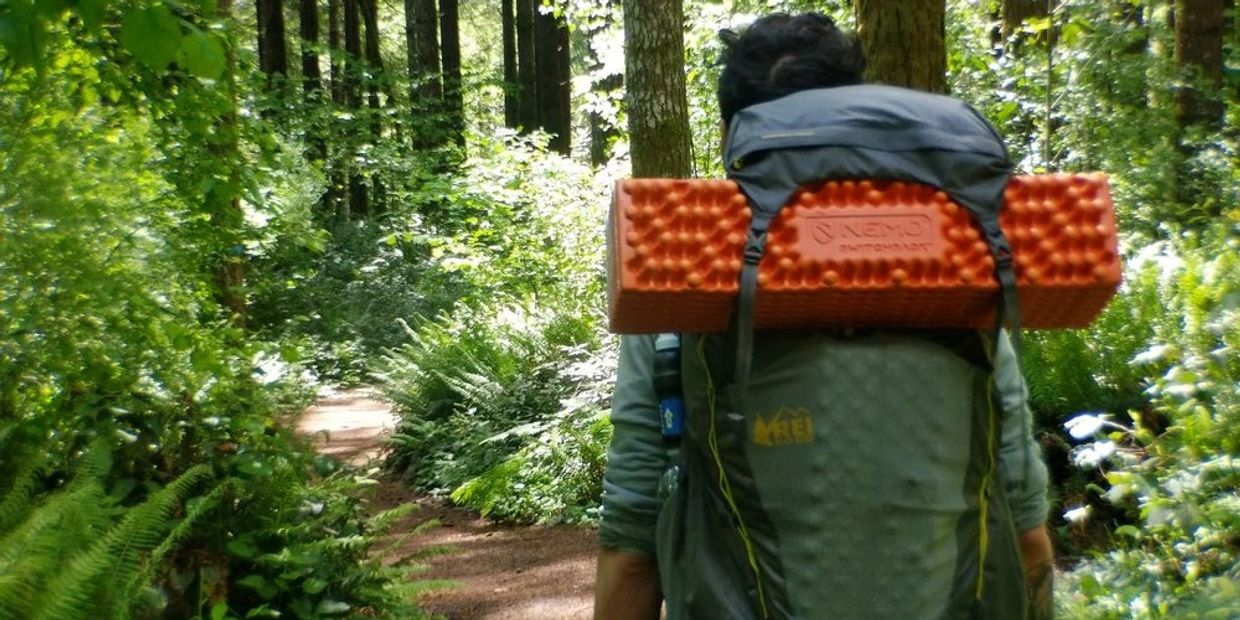 Image of an adventurous man, immersed in the solitude of nature, on a solo hiking and camping trip. 