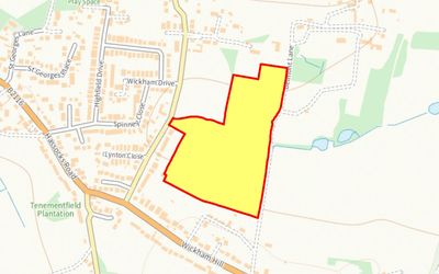 Map highlighting a yellow area outlined in red near a residential neighborhood.