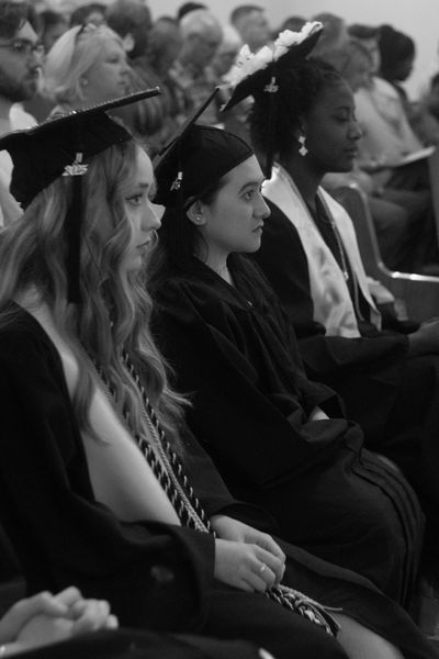 Graduates sitting attentively during a ceremony.