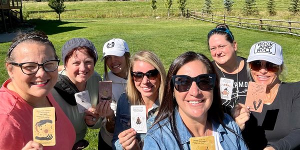 Group of retreat attendees smiling and holding intention cards.