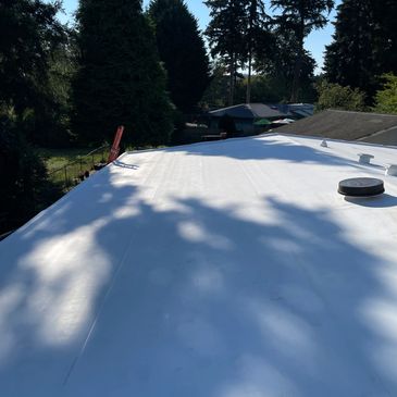 New white TPO roof in Marysville,WA, offering energy efficiency and weather resistance for families.