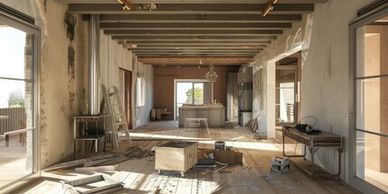 Sunlit rustic room under renovation with exposed beams and scattered tools.