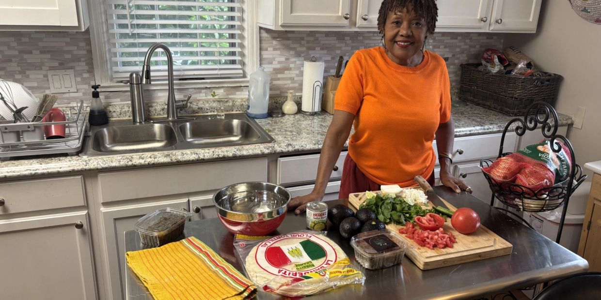 Woman preparing fresh ingredients in a kitchen.
