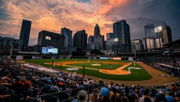 A baseball game at sunset with a city skyline backdrop.