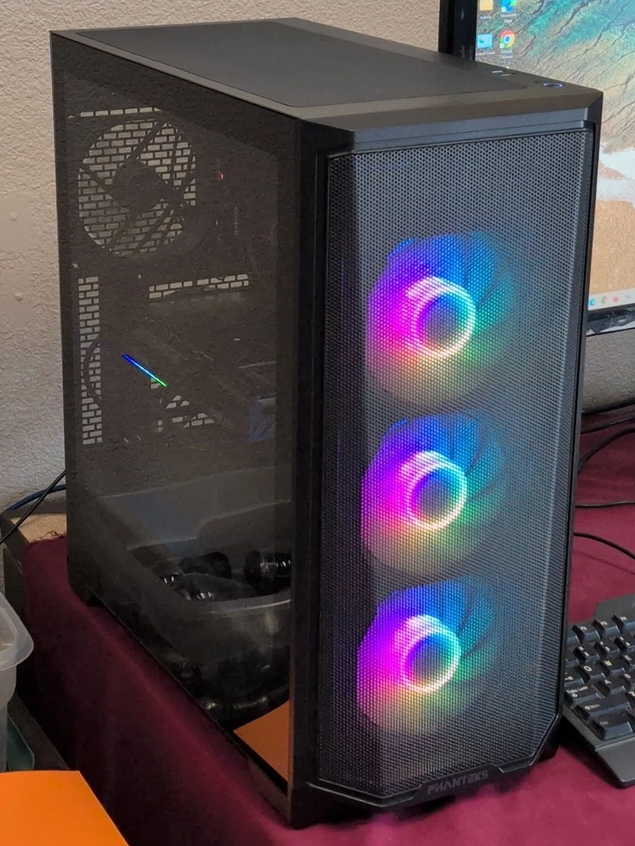 Gaming PC with RGB fans and mesh front panel.