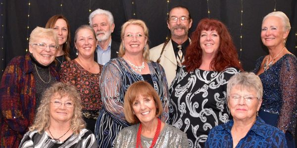 Group of people smiling at a formal event.