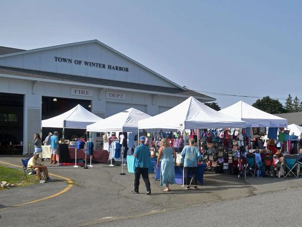 Outdoor market tents set up in front of Winter Harbor Fire Department.