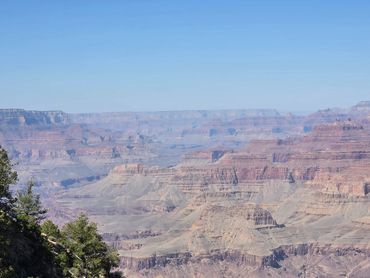 Panoramic view of the Grand Canyon under a clear blue sky.