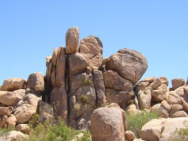 Large rock formations under a clear blue sky.