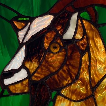 Goat stained glass window panel. 