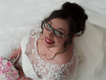 Bride sat in her white wedding dress. wedding photography