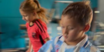 Blurry image of two children playing indoors.