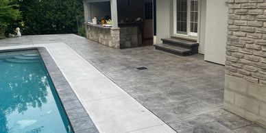 Freshly sealed concrete around a pool deck with anti-slip additives!