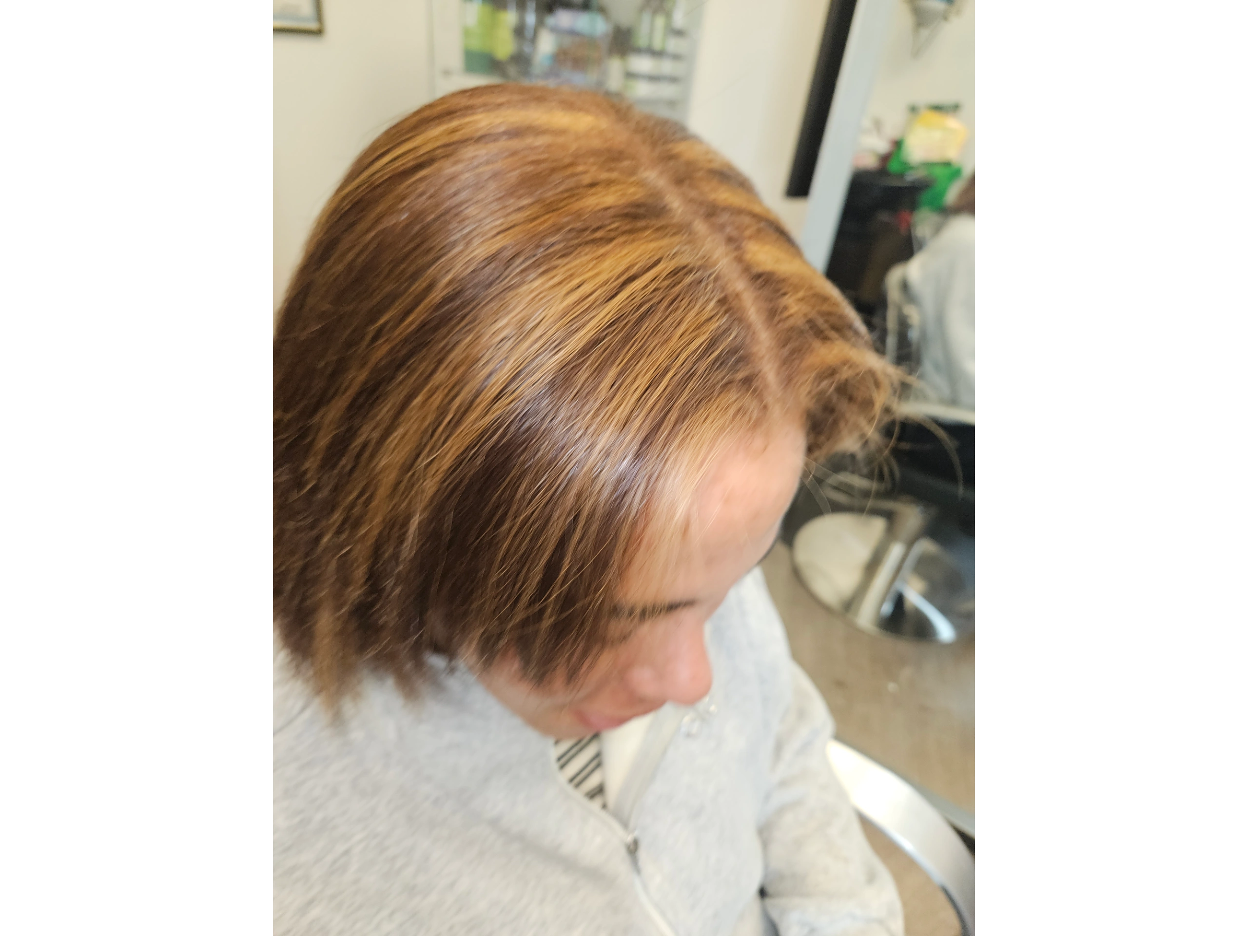 Close-up of a person's light brown hair from above.