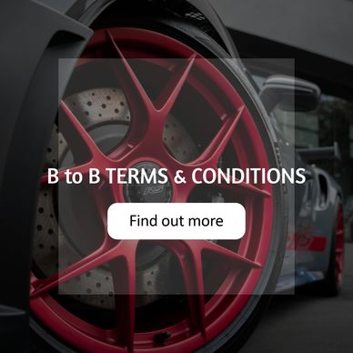 Close-up of a red car wheel with terms and conditions text overlay.