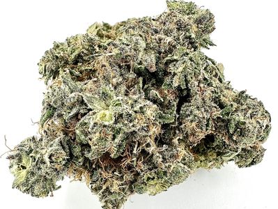 Close-up of a cannabis bud with trichomes and orange hairs.