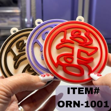 Colorful round ornaments with intricate designs held by hands.