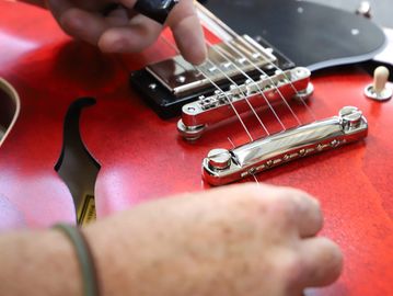 red guitar getting a new string