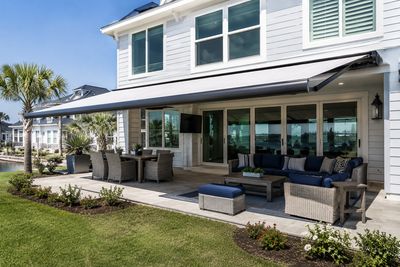 Modern patio with retractable awning and outdoor seating.