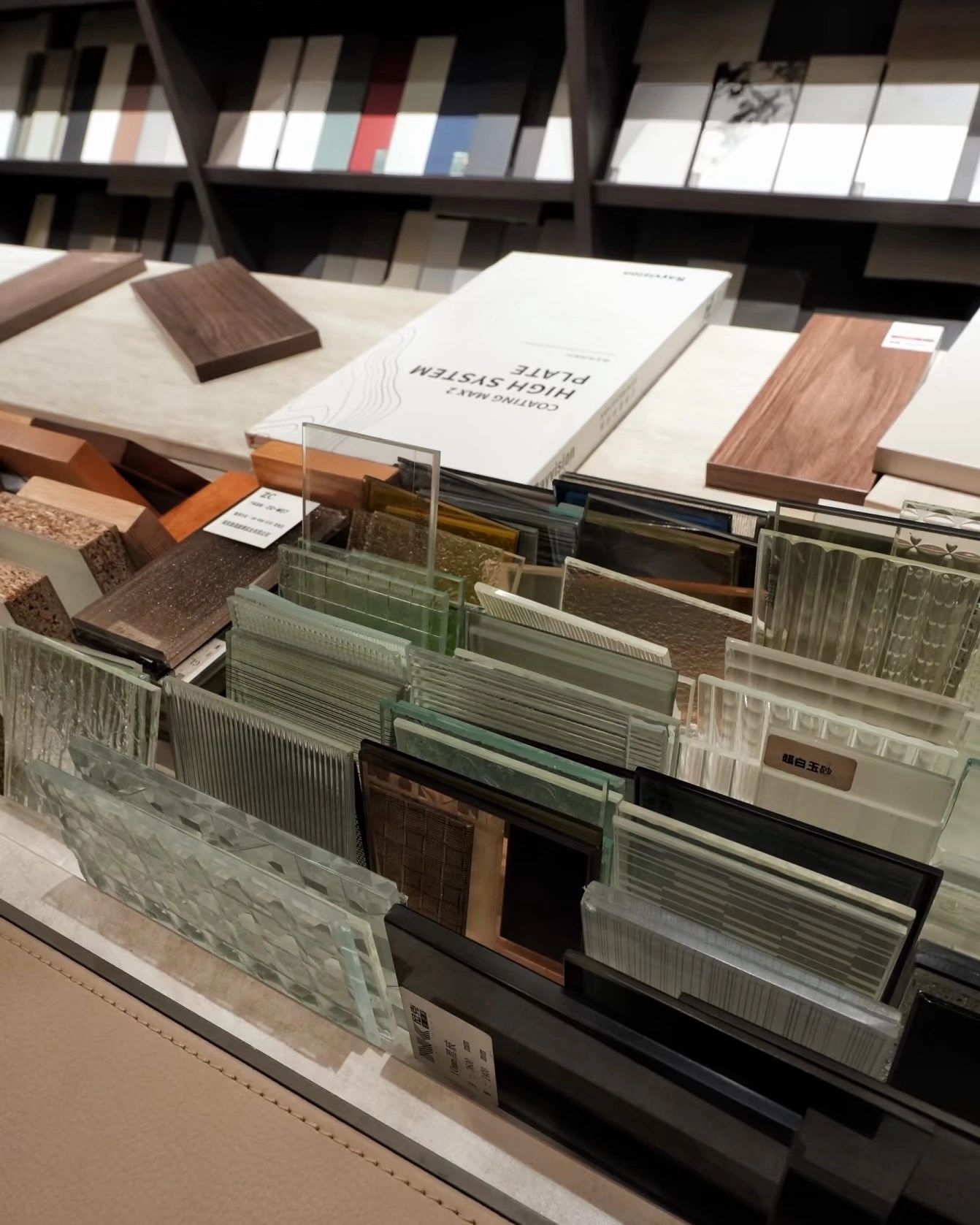 Various glass and wood samples displayed on a table for design selection.