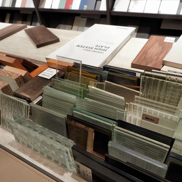 Various glass and wood samples displayed on a table for design selection.