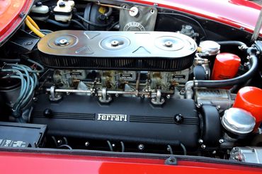 Close-up of a Ferrari engine with three Weber carburetors.