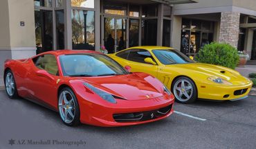 Two vibrant Ferraris parked side by side, one red and one yellow.