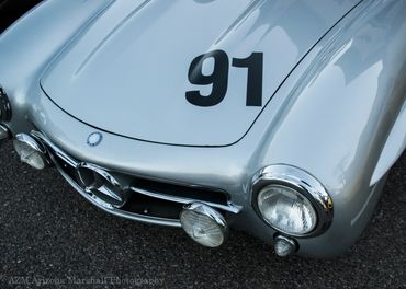 Close-up of a vintage silver Mercedes-Benz car with racing number 91.