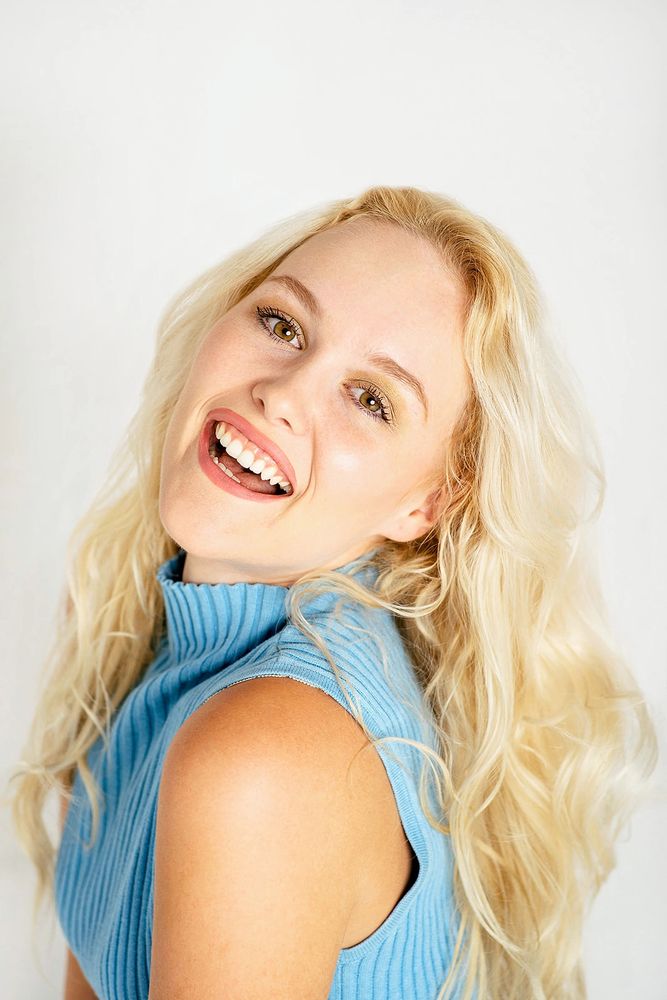 Women with bright smile representing teeth whitening and tooth gem in Mesa, Az