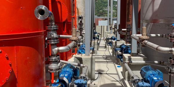 Industrial pipes and pumps in a facility.