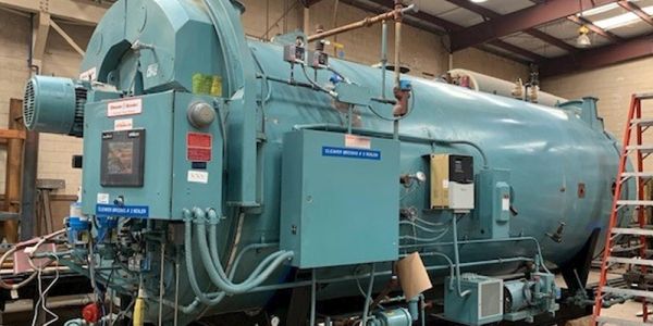 Industrial autoclave machine in a workshop.