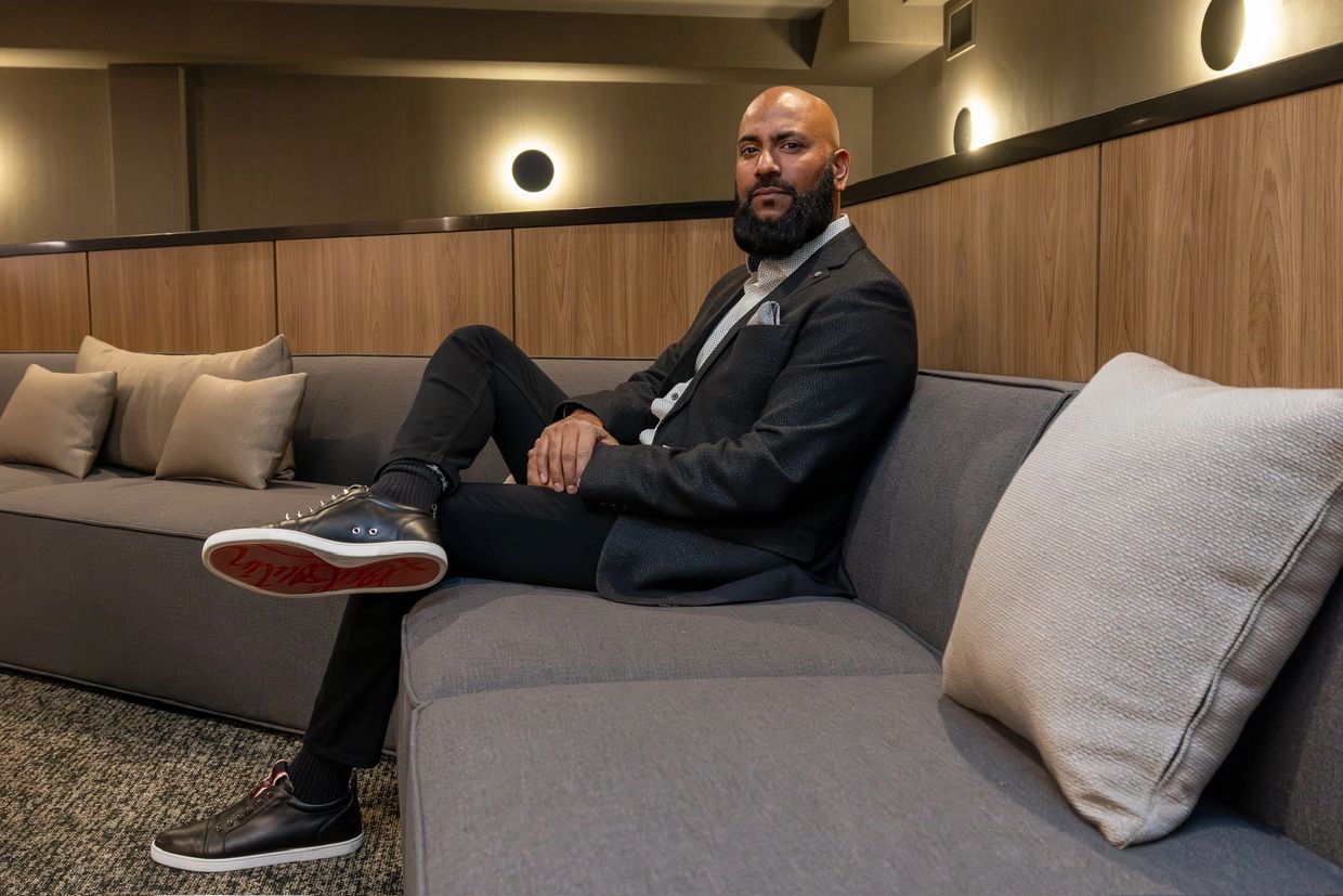 Man sitting on a modern couch in a stylish room.