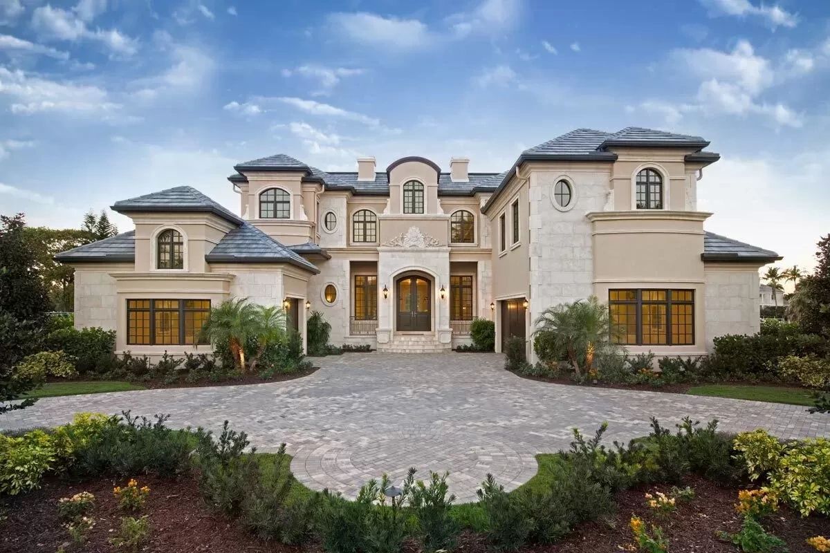 Large luxury house with elegant architecture and a spacious driveway.