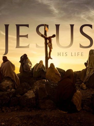 Jesus on the cross with followers at sunset.