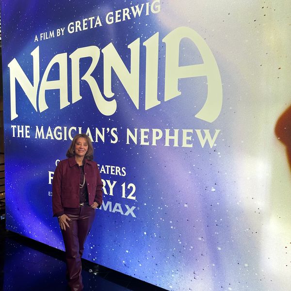 Person posing in front of Narnia movie poster.