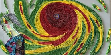 Colorful quilling art featuring a woman and swirling patterns in green, yellow, and red.