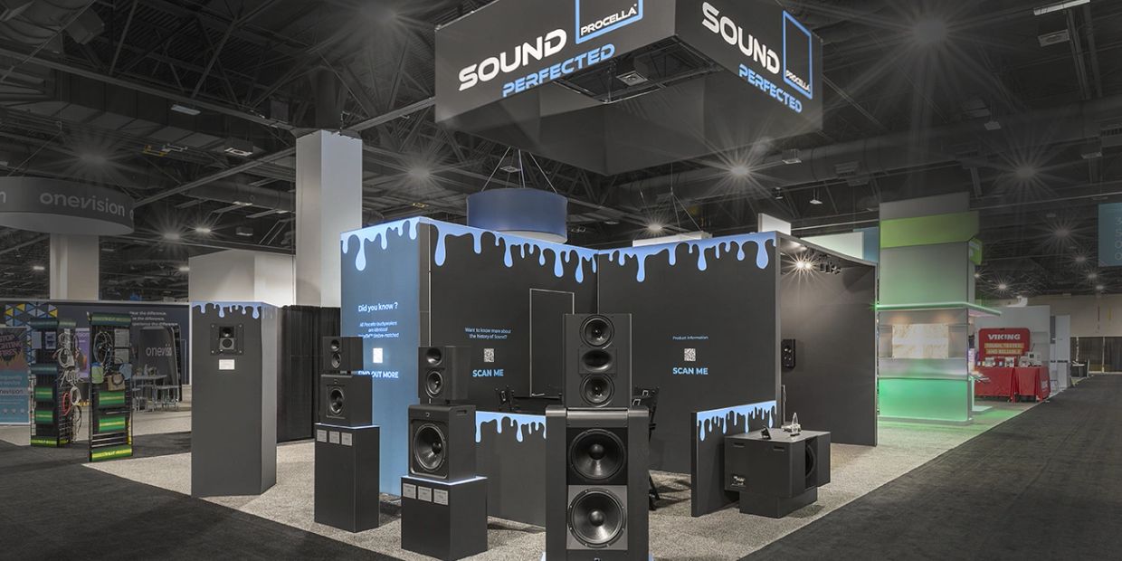 Modern sound equipment display at a trade show booth.