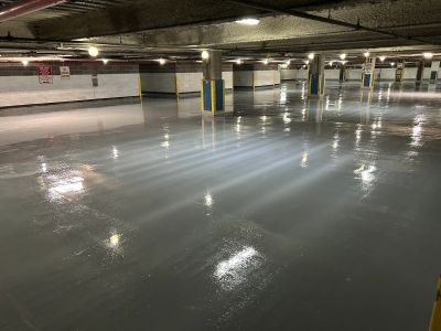 Shiny wet floor in an empty underground parking garage.