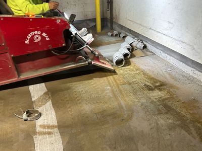 A person operating a BlastPro Recycler machine on a concrete floor indoors.