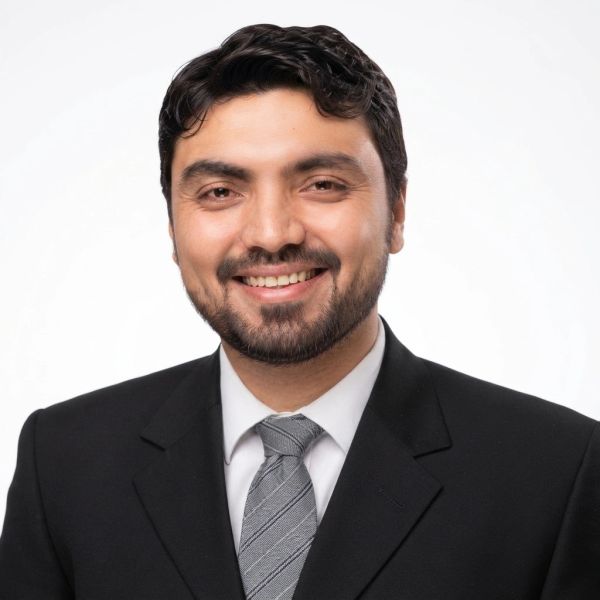 Smiling man in a suit and tie.