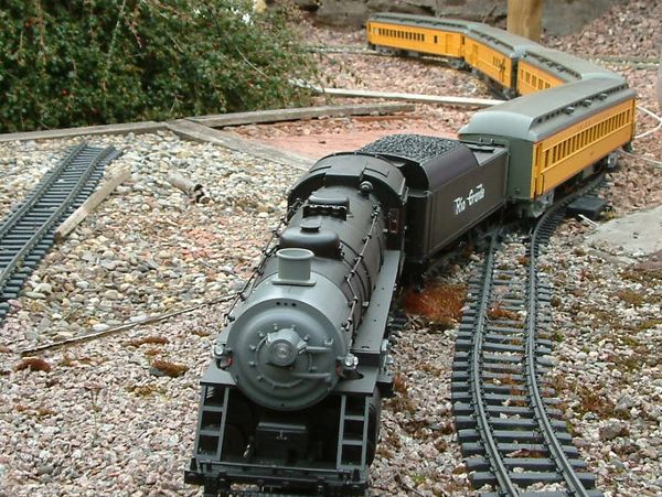 Miniature model train showcased outdoors in a garden