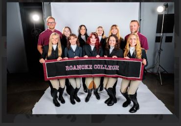 Roanoke College group photo with students holding a banner.