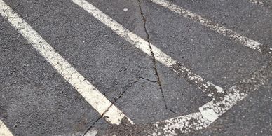 Parking lot in need of new sealcoating, asphalt crack repair and paint line striping