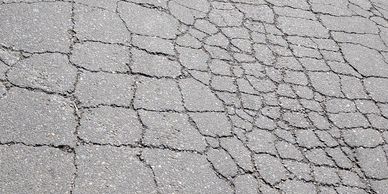 Parking lot with alligator cracking in need of asphalt crack repair