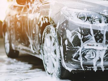 Car Detailing car washed and soaked with soapy car cleaner 