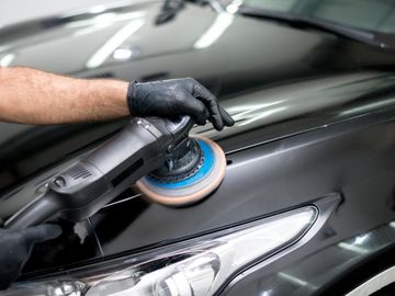 Car Detailing black car being machine polished 